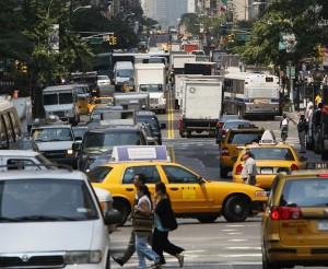 Cars, taxis and trucks sit in traffic in